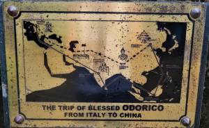 Odoric plaque on front of church in Bolinao